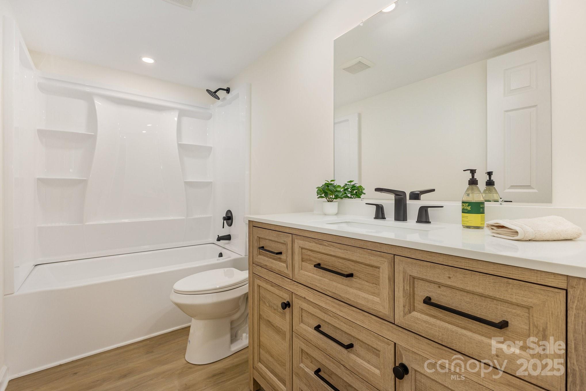 12180 A Coyle Road Stanfield, NC 28163 - Photo 13 of 16 a bathroom with a sink a toilet and shower