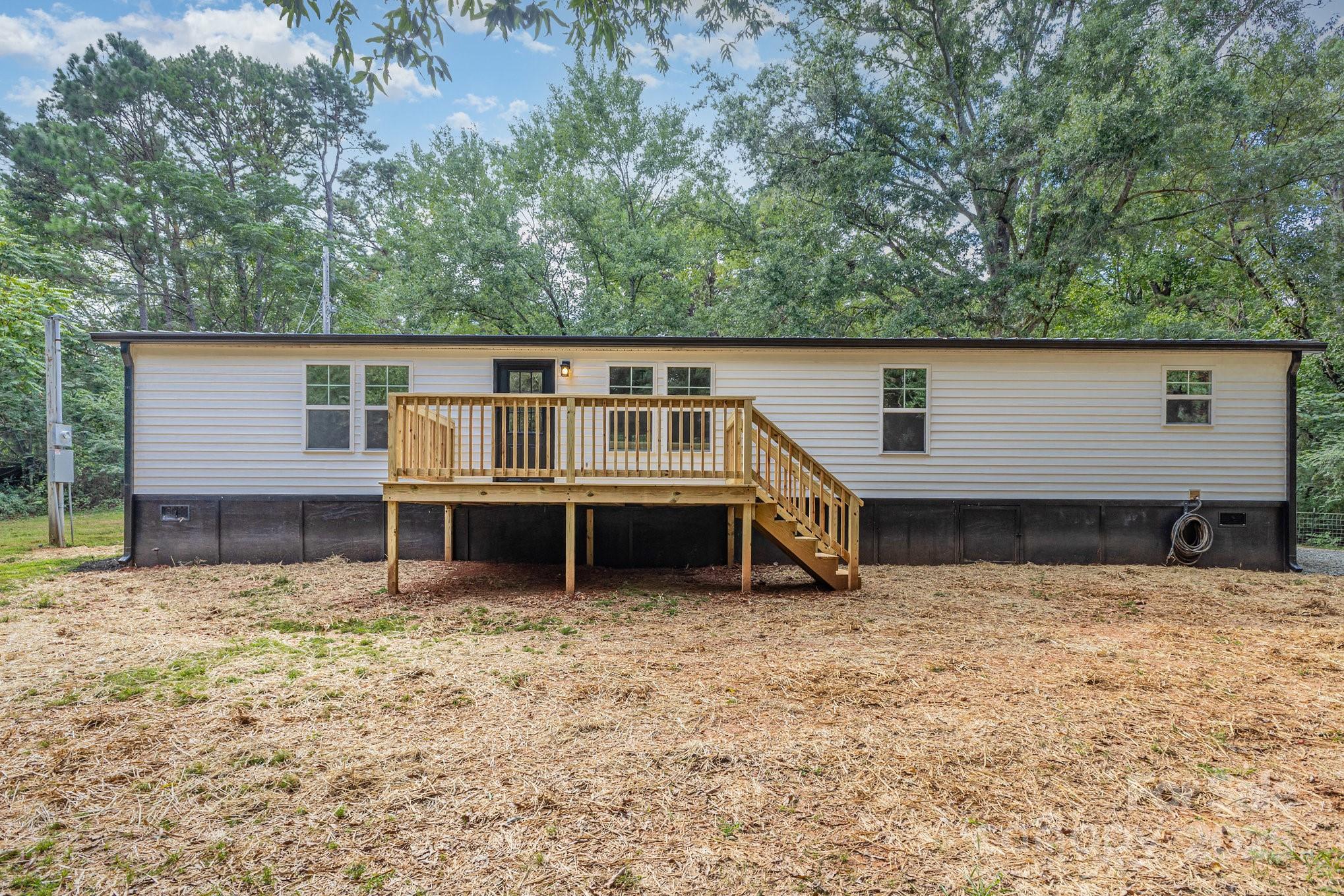 12180 A Coyle Road Stanfield, NC 28163 - Photo 15 of 16 a view of a house with a yard