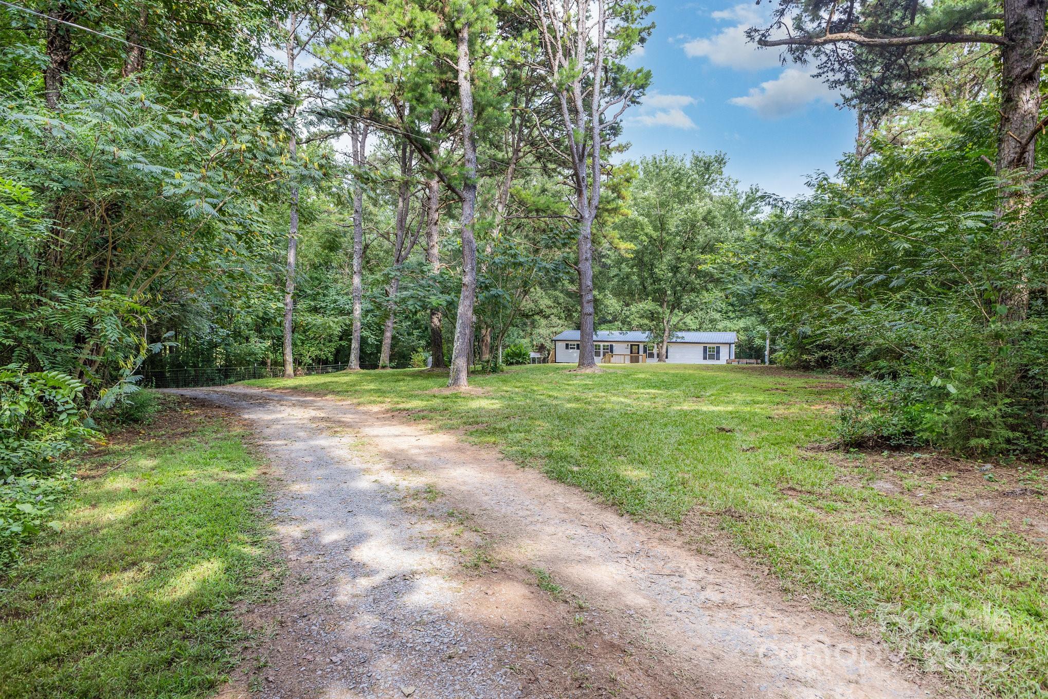 12180 A Coyle Road Stanfield, NC 28163 - Photo 16 of 16 a view of green field with trees in the background