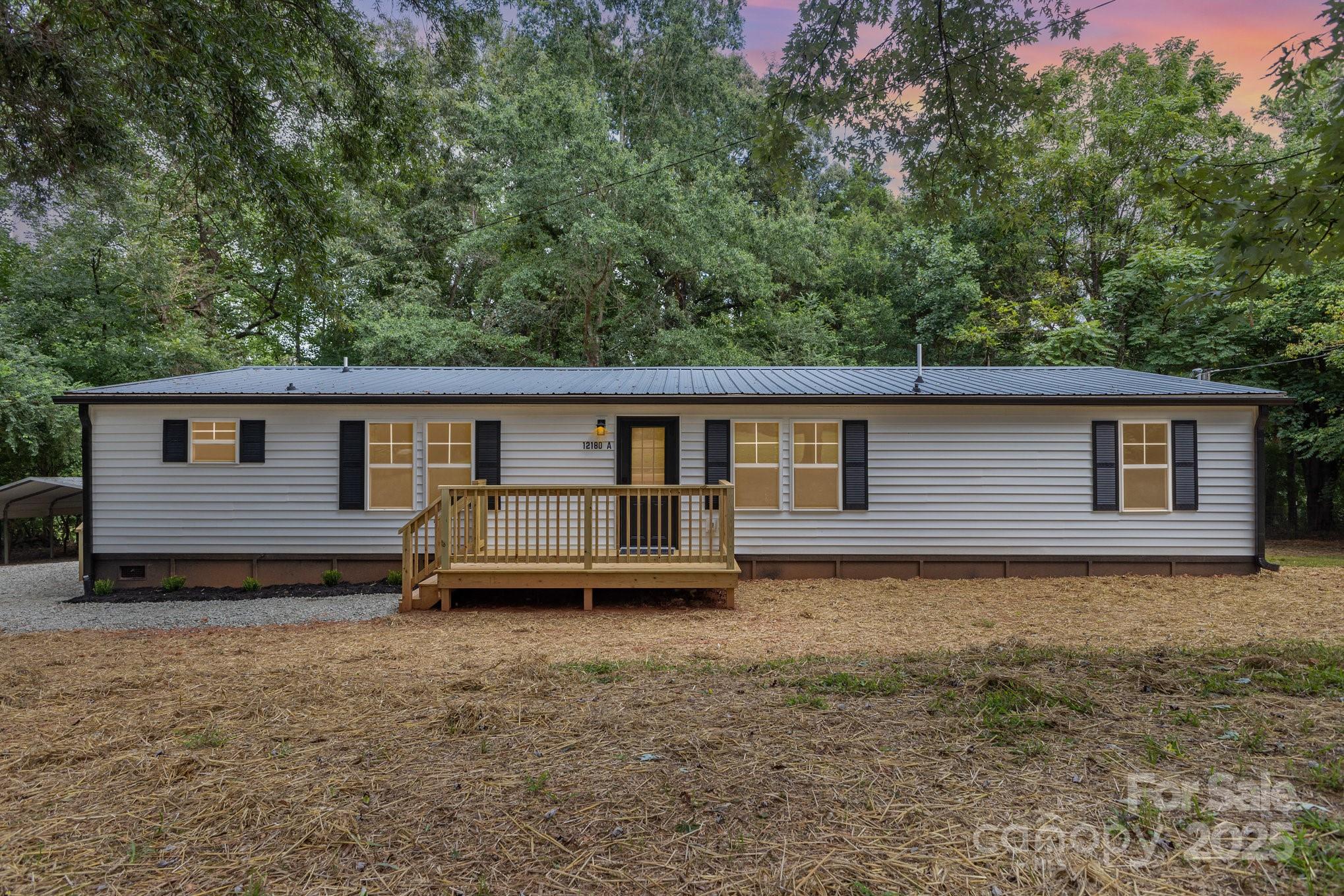 12180 A Coyle Road Stanfield, NC 28163 - Photo 2 of 16 front view of a house with a yard