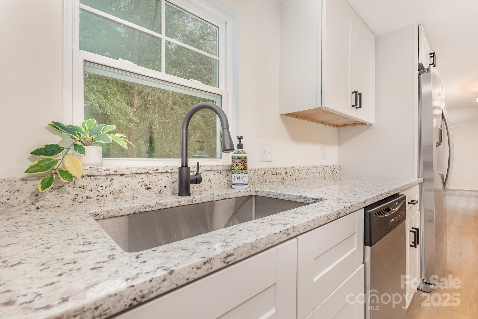 12180 A Coyle Road Stanfield, NC 28163 - Photo 7 of 16 a view of a kitchen counter top a sink and dishwasher with wooden floor