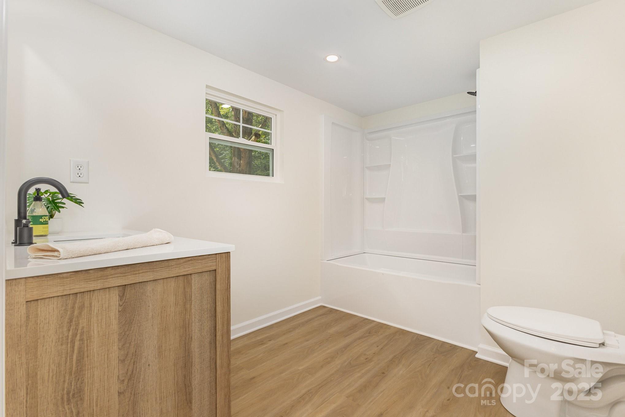 12180 A Coyle Road Stanfield, NC 28163 - Photo 10 of 16 a bathroom with a sink a toilet and shower