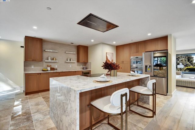 a large kitchen with a table and chairs in it