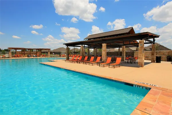 a view of a swimming pool with lounge chairs