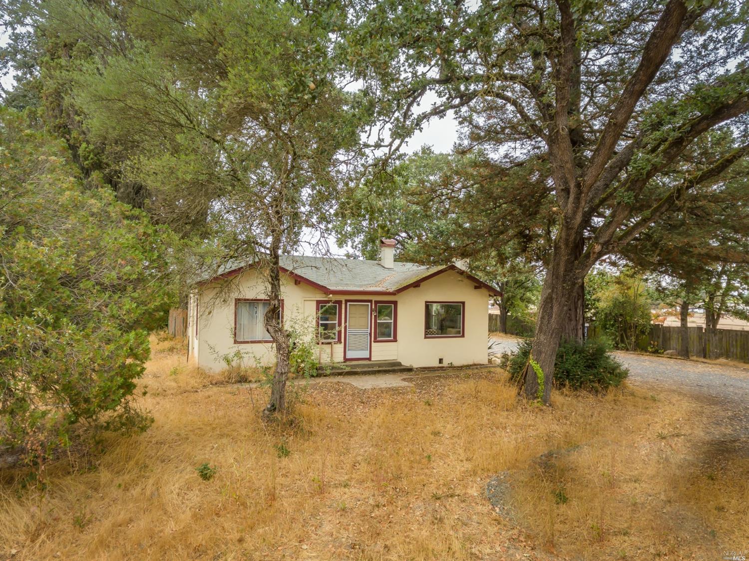 3377 Guerneville Road Santa Rosa, CA 95401 - Photo 1 of 1 a front view of a house with yard and trees