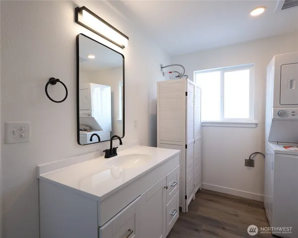 a bathroom with a sink a mirror and vanity