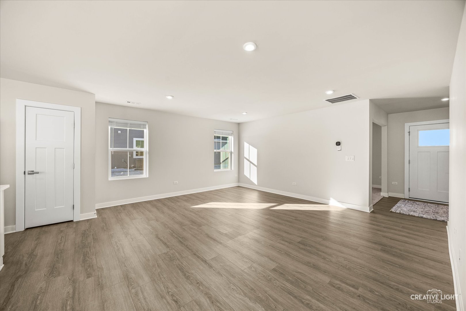 1237 Marigold Lane Hampshire, IL 60140 - Photo 11 of 34 an empty room with wooden floor and windows