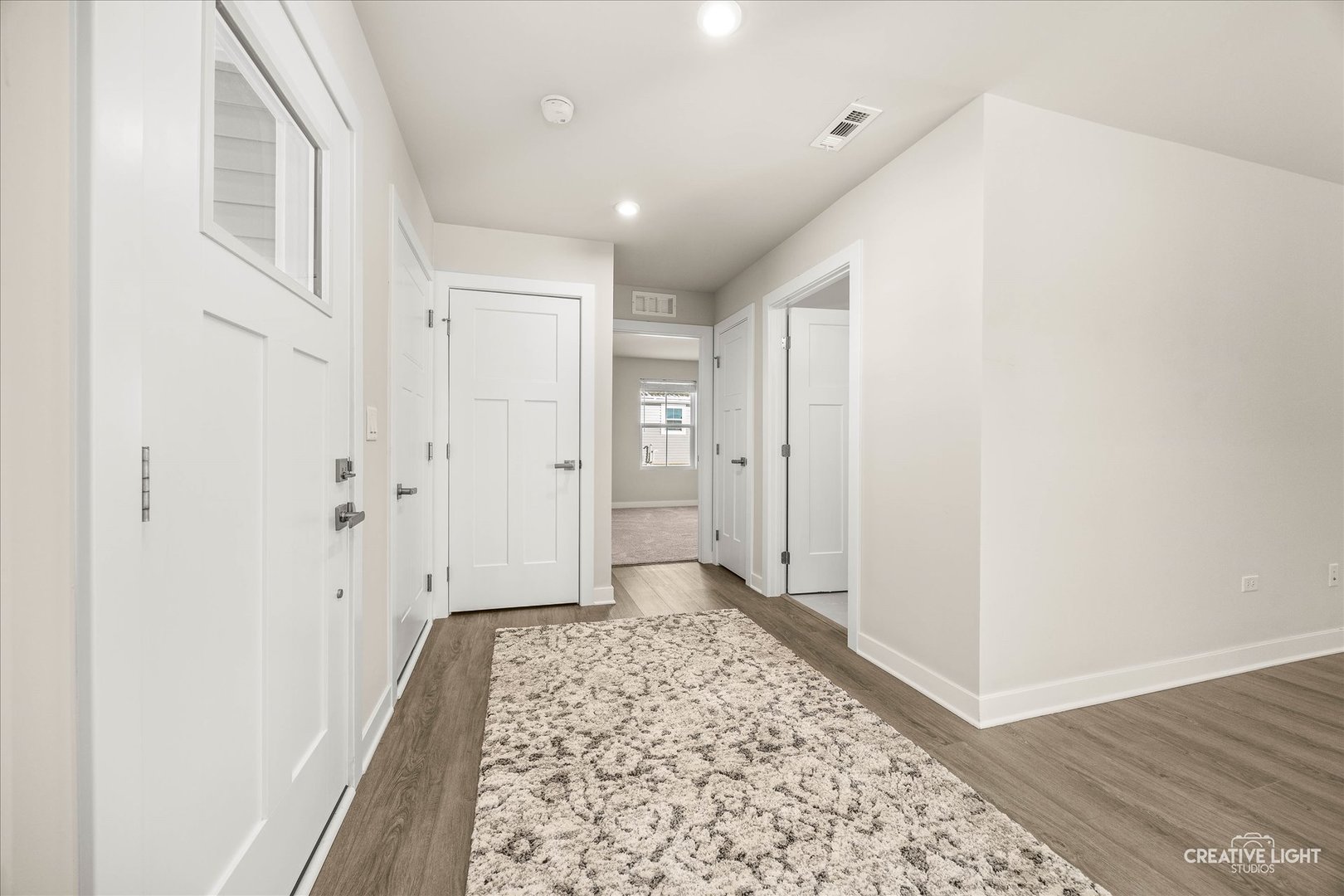1237 Marigold Lane Hampshire, IL 60140 - Photo 7 of 34 a view of a hallway with wooden floor and a bathroom