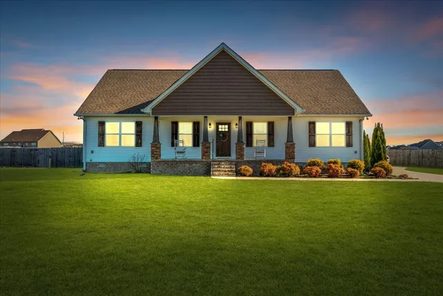 a front view of a house with swimming pool having outdoor seating