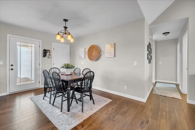a view of a dining room with furniture and wooden floor
