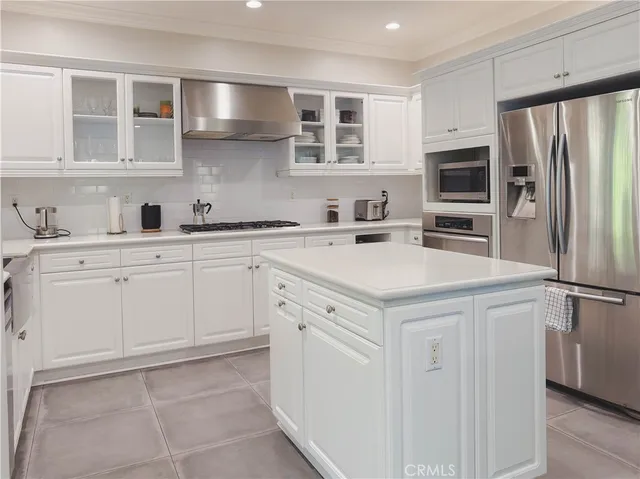 a kitchen with white cabinets and white appliances