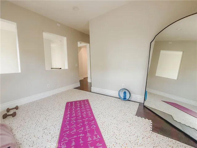 a bedroom with a bed and a wooden floor