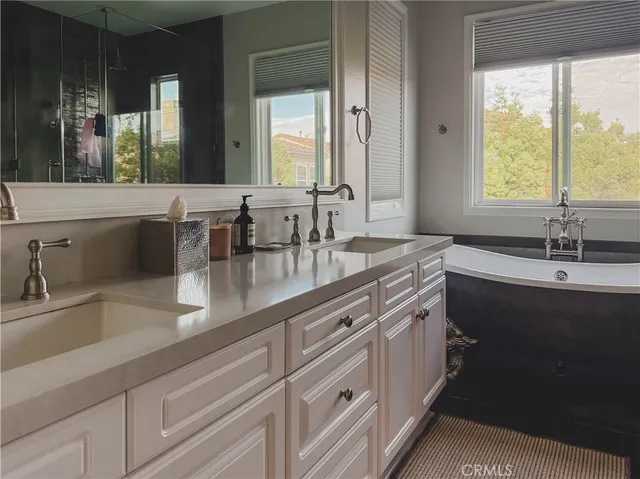 a bathroom with double sink and a mirror