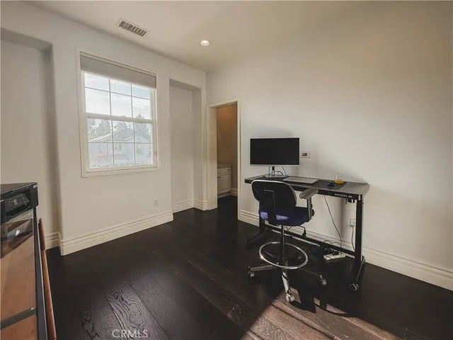 a view of workspace with wooden floor windows