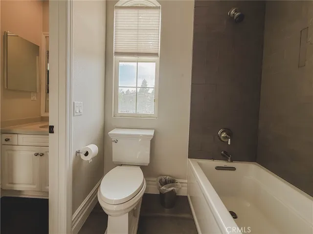 a bathroom with a toilet sink and shower