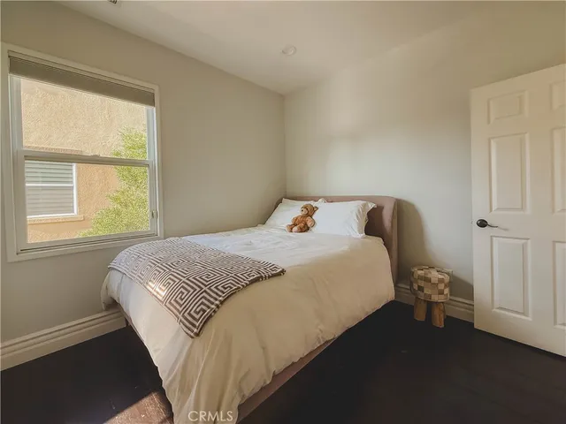 a large bed sitting in a bedroom next to a window