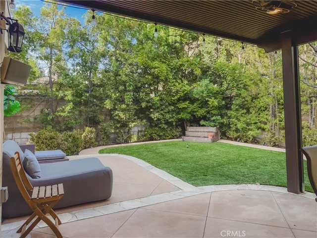 a view of a patio with a table and chairs under an umbrella