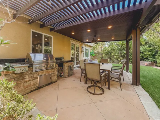 a dining room with furniture and large windows
