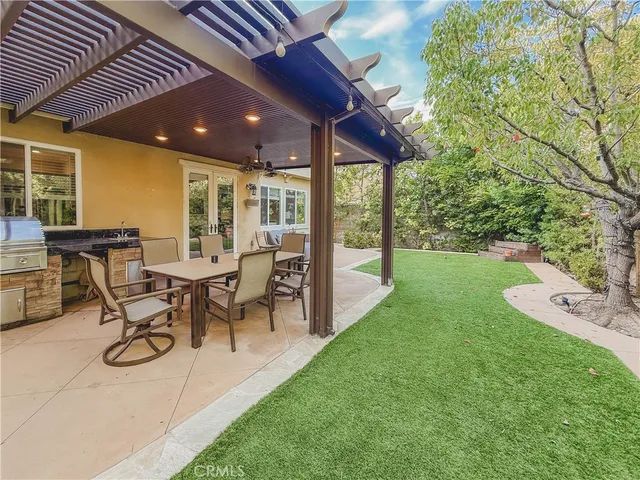 a view of a patio with table and chairs and garden