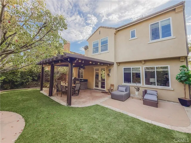 a view of a house with a backyard patio and sitting area