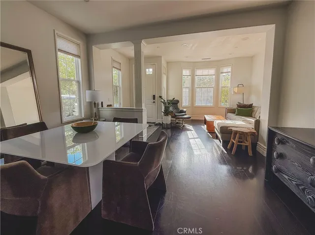 a living room with fireplace furniture and a large window