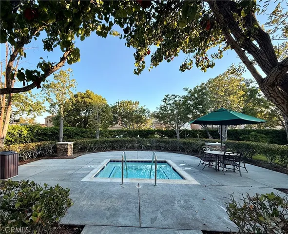 a swimming pool with outdoor seating and yard