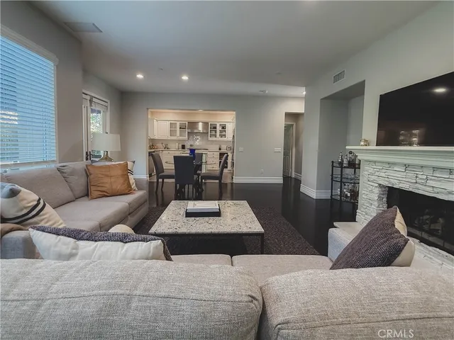 a living room with furniture a flat screen tv and a fireplace
