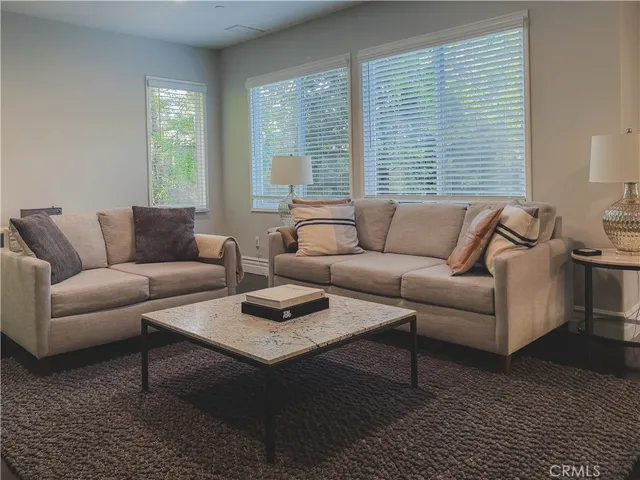 a living room with furniture and a large window