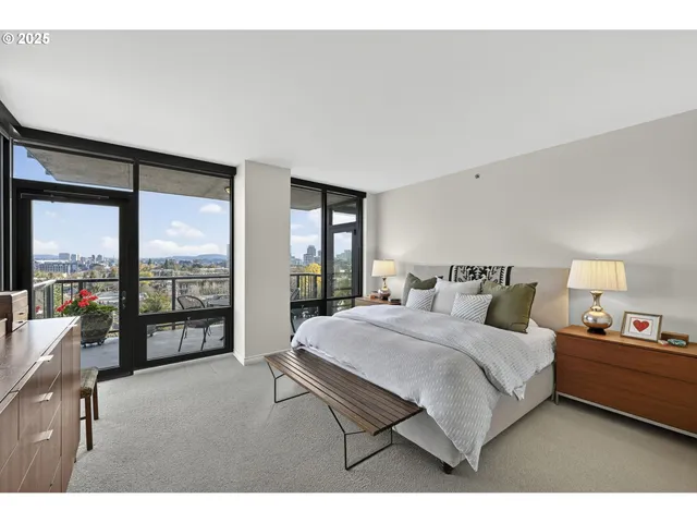 a bedroom with a large bed and a large window