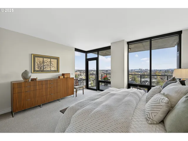 a bedroom with furniture and a large window