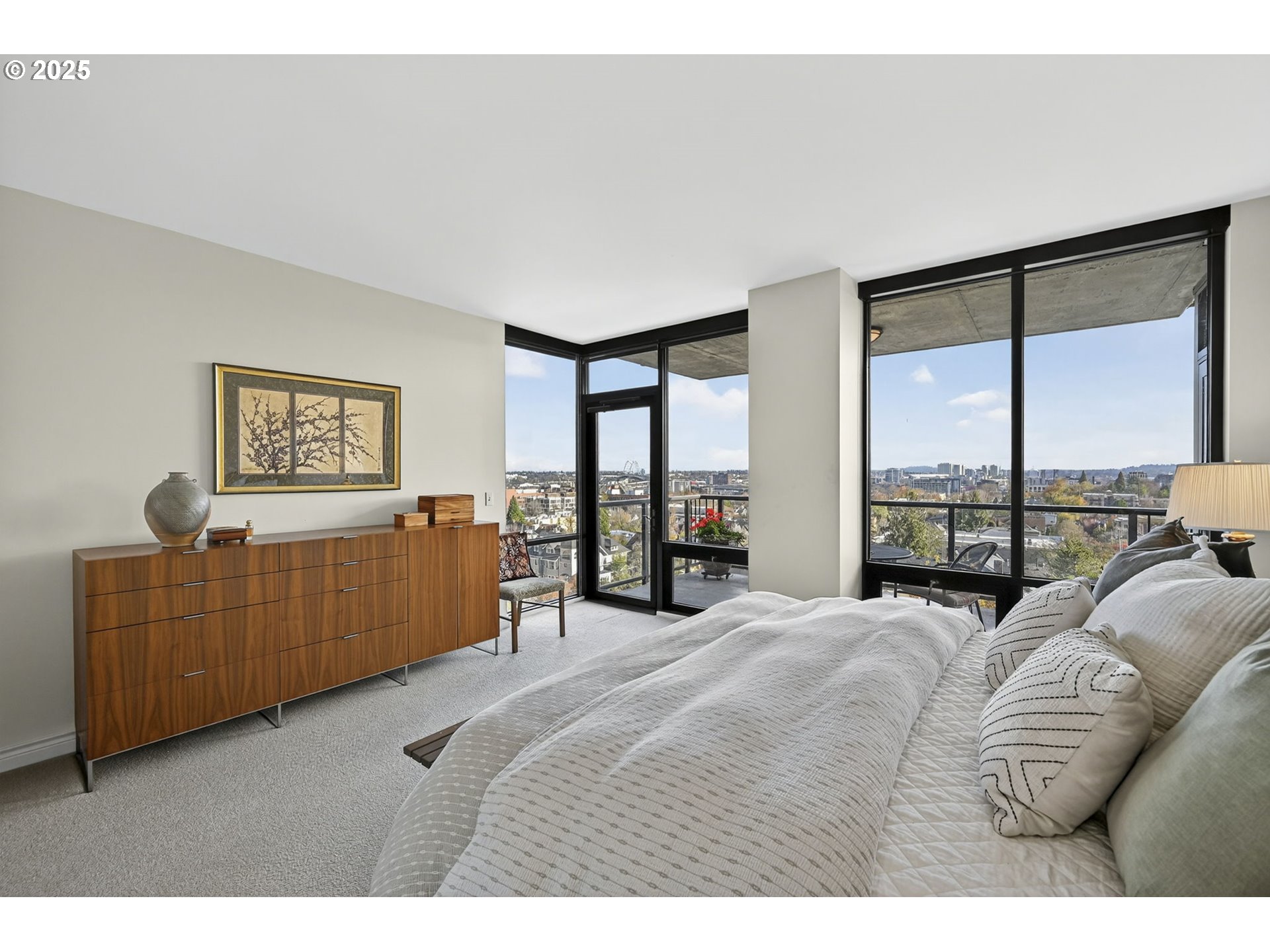 2448 Northwest Westover Road, Unit E402 Portland, OR 97210 - Photo 14 of 31 a bedroom with furniture and a large window