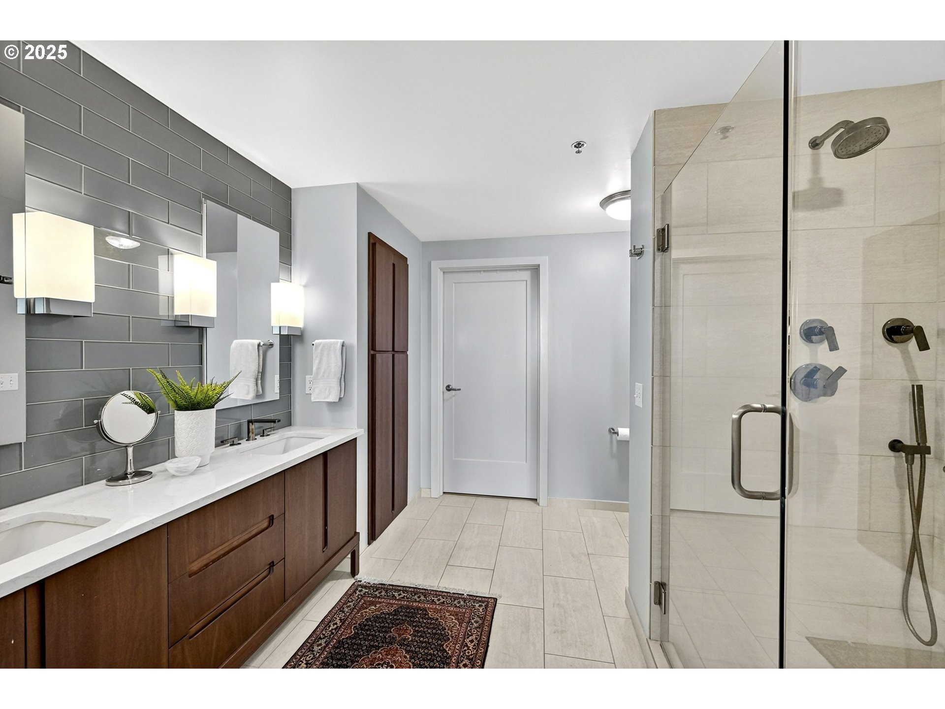 2448 Northwest Westover Road, Unit E402 Portland, OR 97210 - Photo 15 of 31 a bathroom with a granite countertop sink mirror and shower