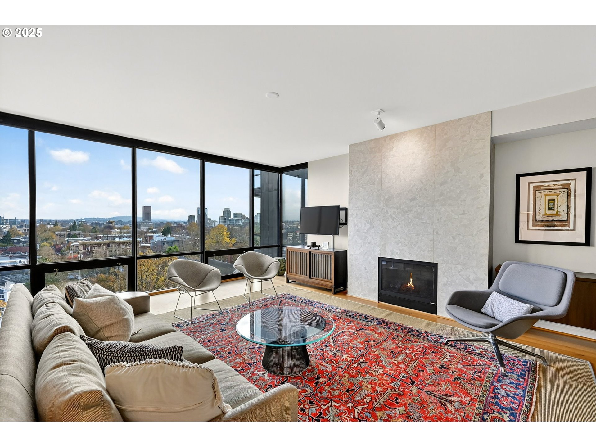 2448 Northwest Westover Road, Unit E402 Portland, OR 97210 - Photo 2 of 31 a living room with furniture large windows and a fireplace