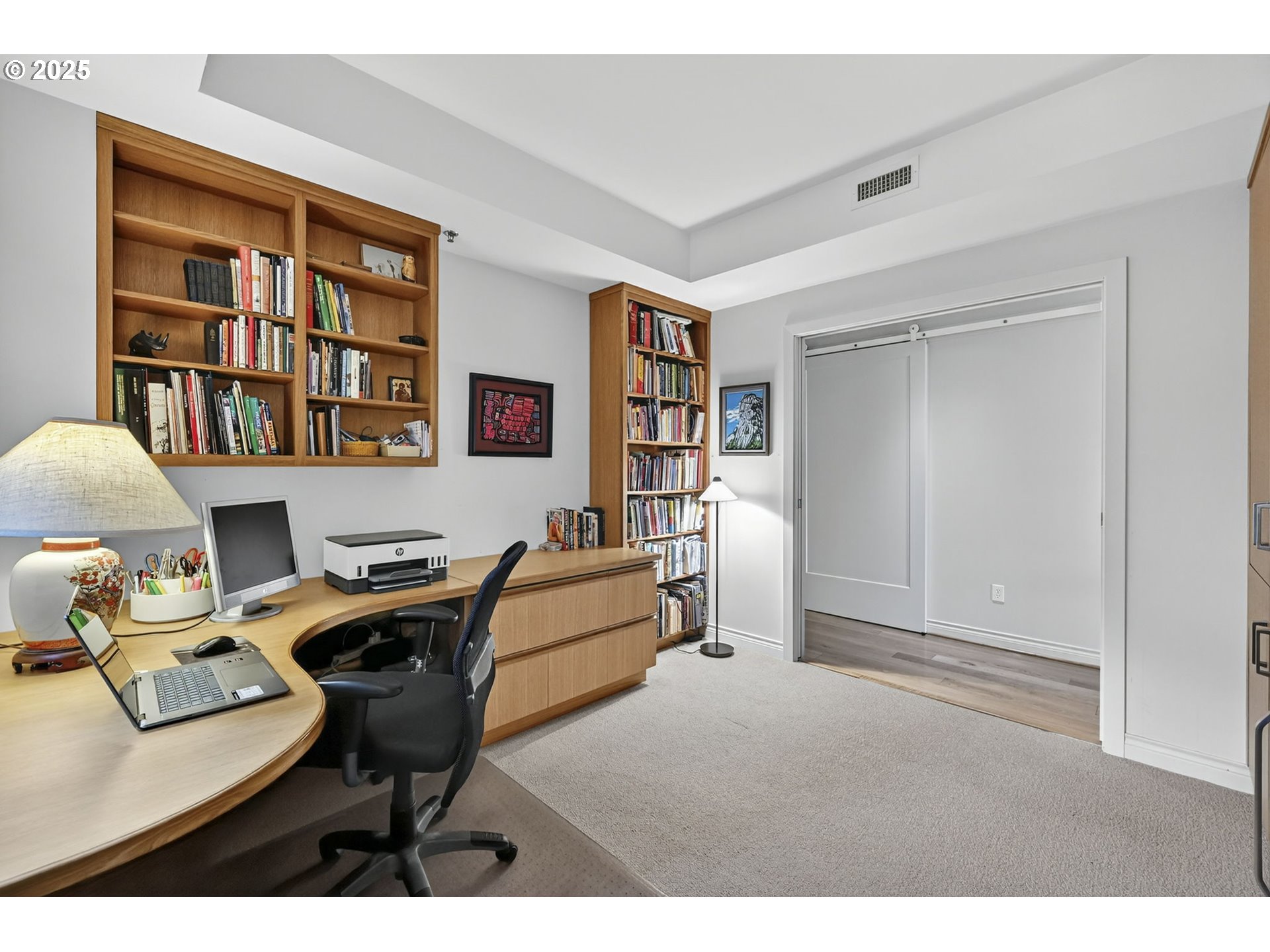 2448 Northwest Westover Road, Unit E402 Portland, OR 97210 - Photo 21 of 31 a workspace with furniture and a bookshelf
