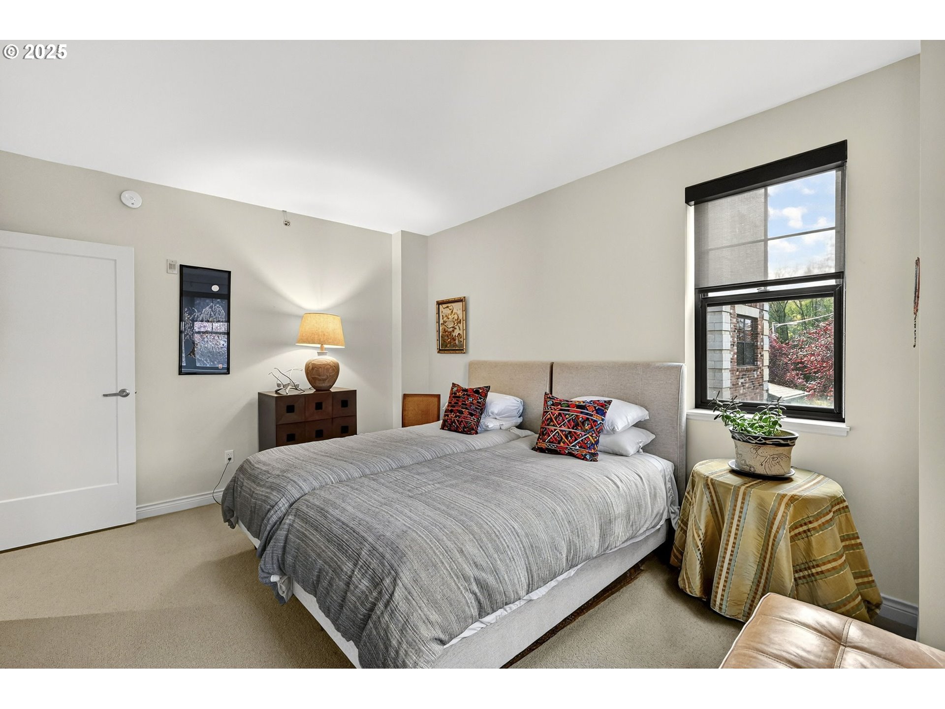 2448 Northwest Westover Road, Unit E402 Portland, OR 97210 - Photo 22 of 31 a bedroom with a bed and a window