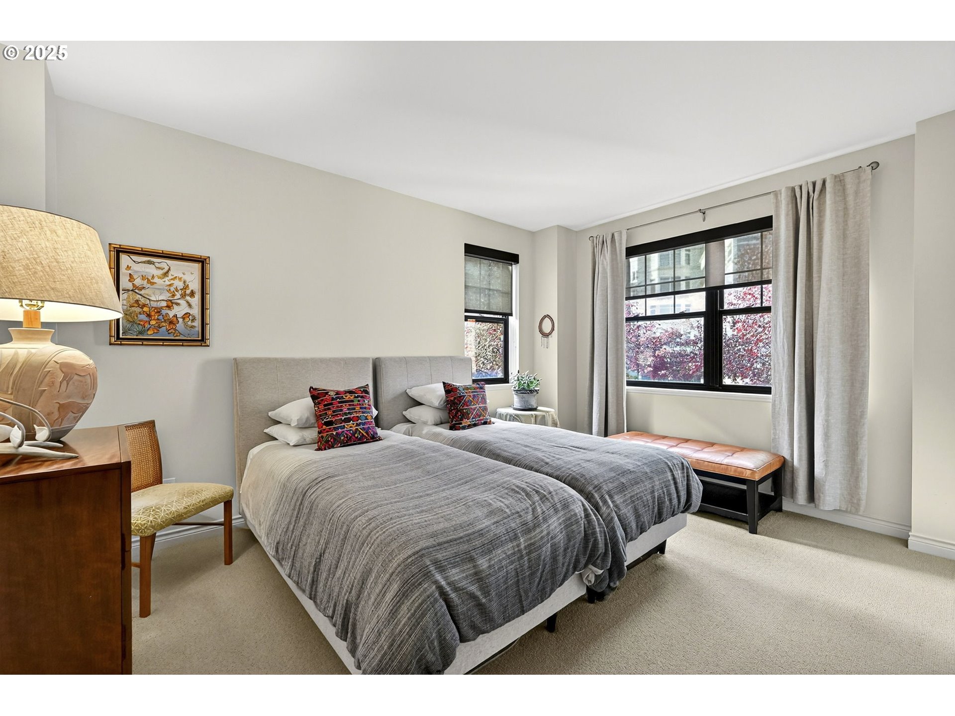 2448 Northwest Westover Road, Unit E402 Portland, OR 97210 - Photo 24 of 31 a bedroom with a bed and wooden floor