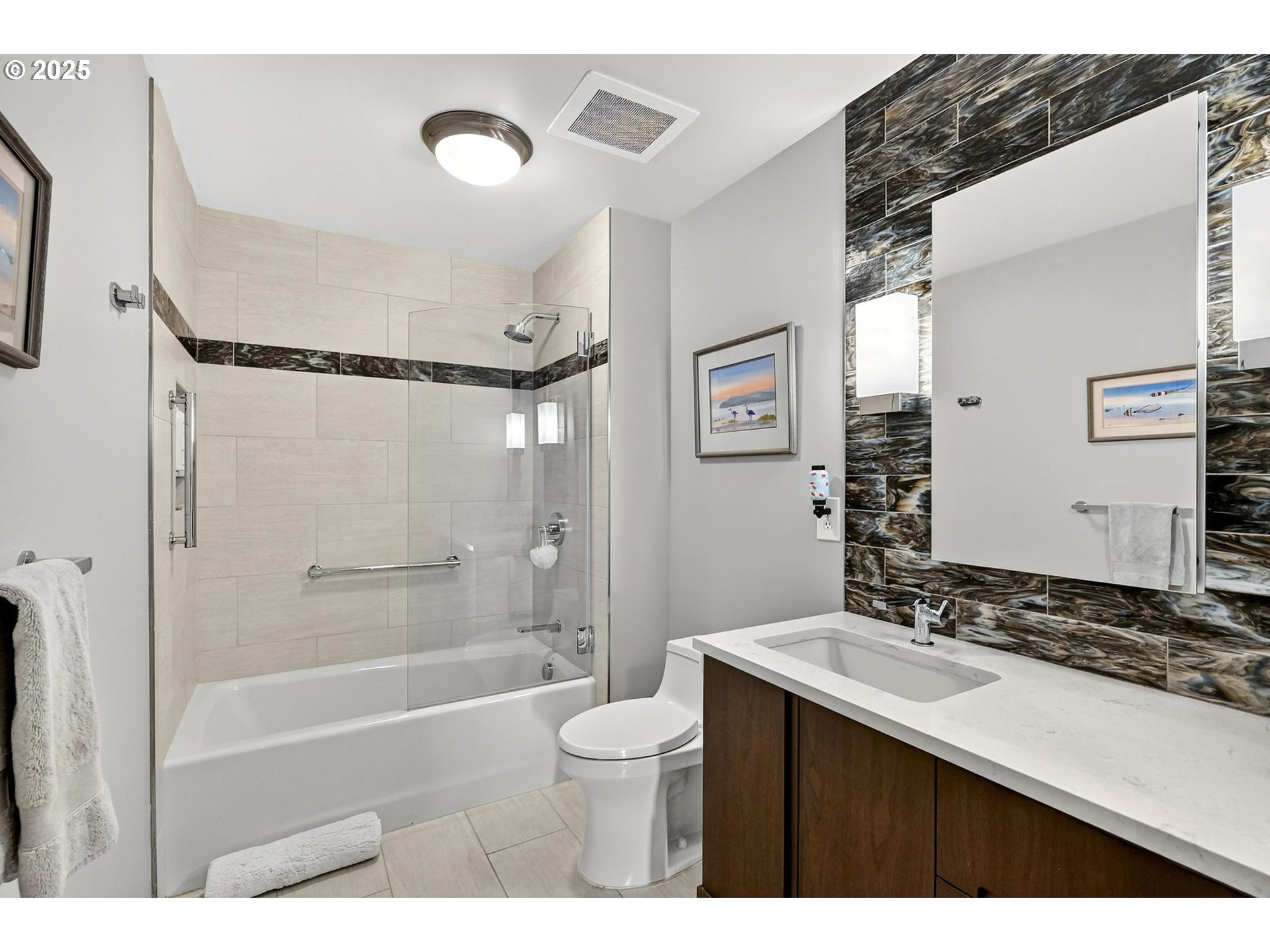 2448 Northwest Westover Road, Unit E402 Portland, OR 97210 - Photo 25 of 31 a bathroom with a bathtub shower sink vanity and toilet
