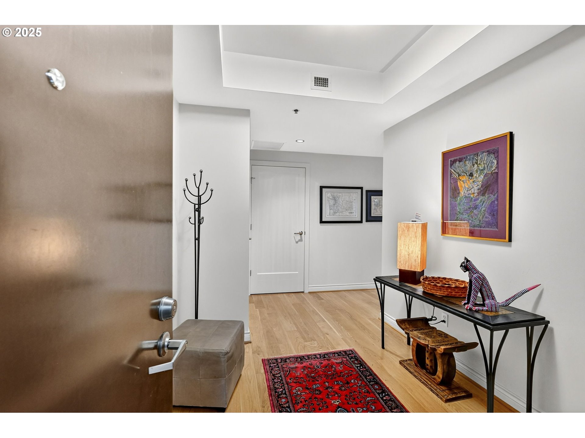 2448 Northwest Westover Road, Unit E402 Portland, OR 97210 - Photo 27 of 31 a living room with furniture and wooden floor