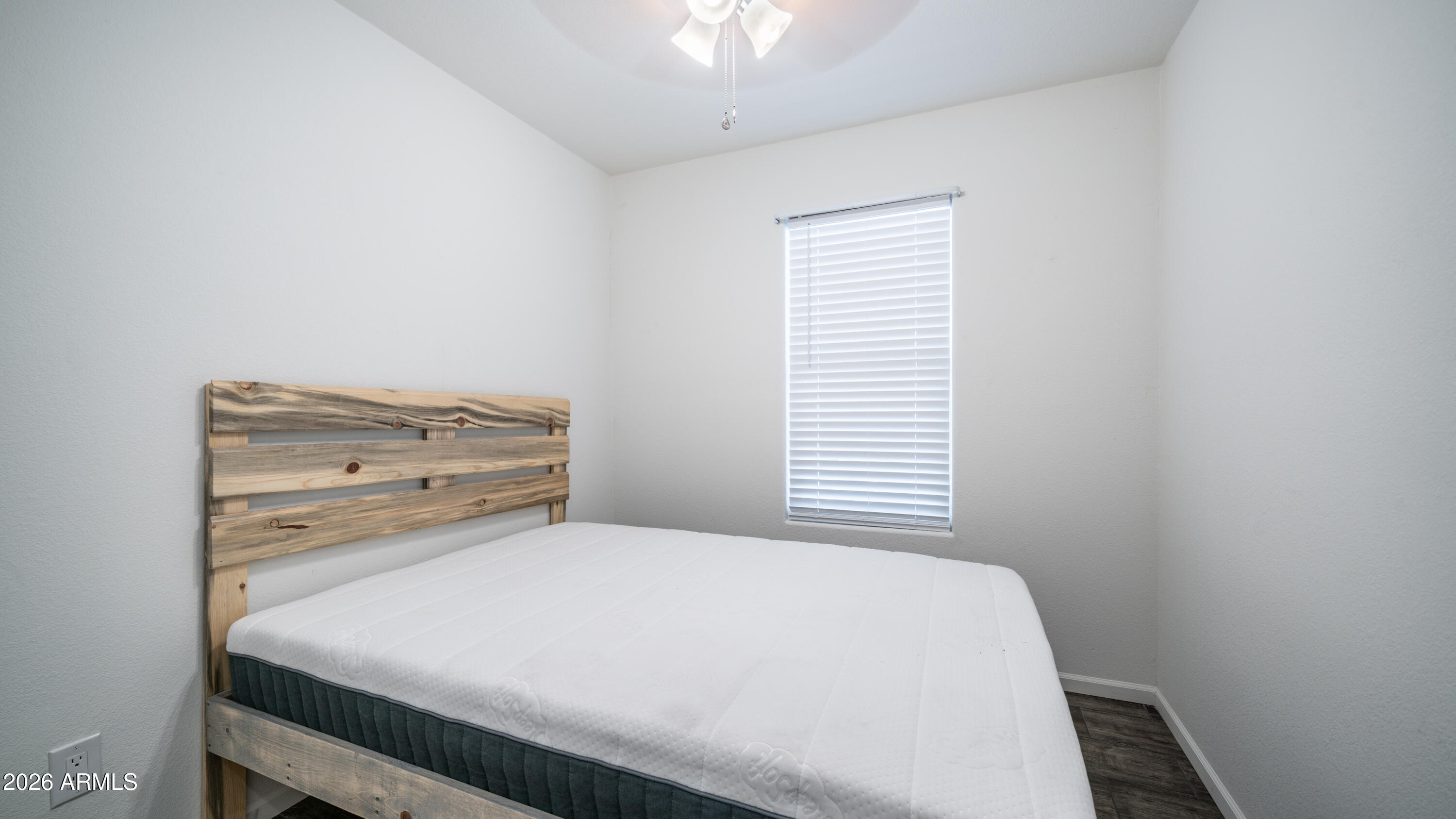 2929 East Main Street, Unit 237 Mesa, AZ 85213 - Photo 12 of 20 a bed sitting in a bedroom next to a window