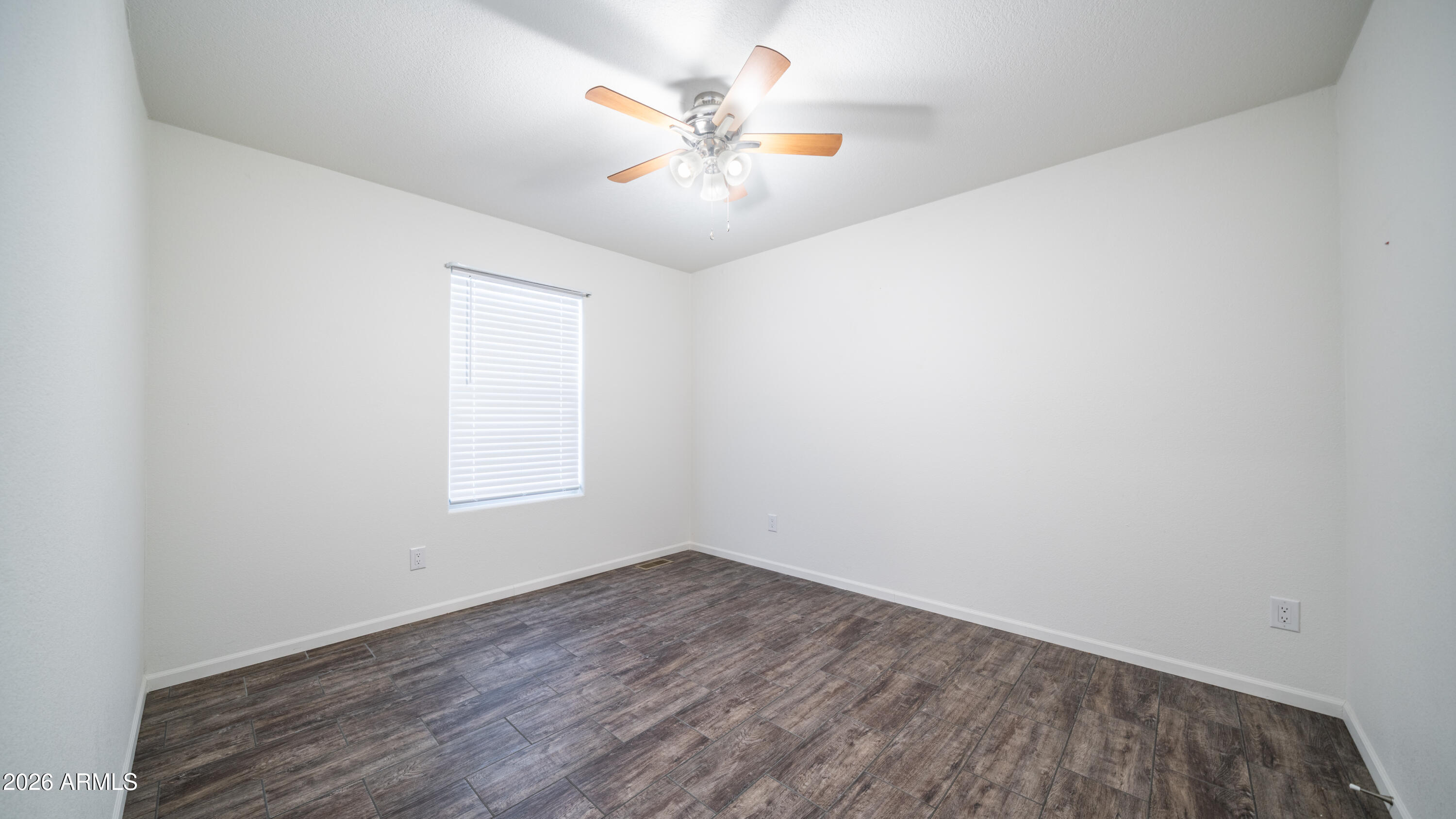 2929 East Main Street, Unit 237 Mesa, AZ 85213 - Photo 15 of 20 an empty room with a window and a fan
