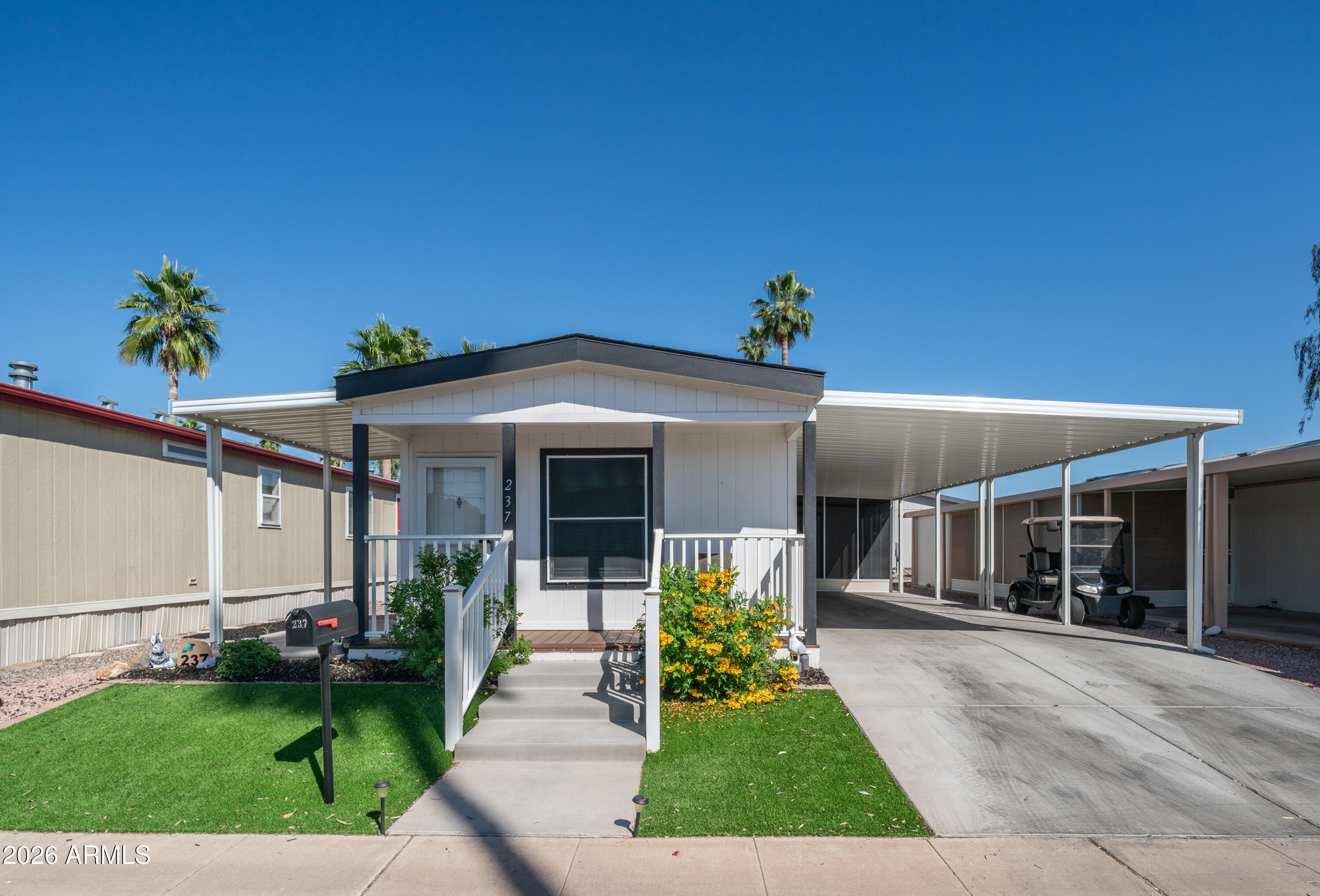 2929 East Main Street, Unit 237 Mesa, AZ 85213 - Photo 2 of 20 a front view of a house with a yard