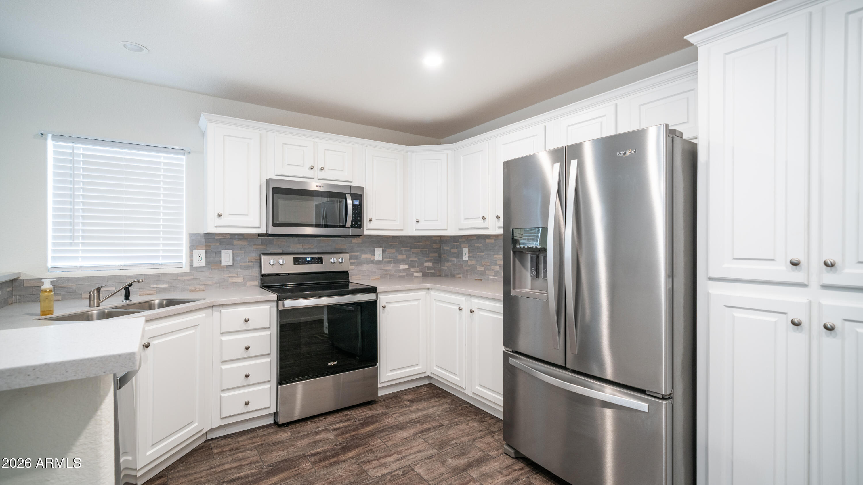 2929 East Main Street, Unit 237 Mesa, AZ 85213 - Photo 8 of 20 a kitchen with stainless steel appliances a refrigerator sink and microwave