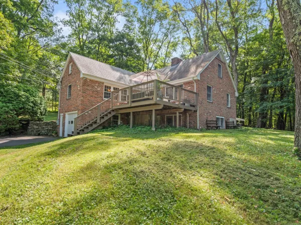 a front view of a house with a garden and yard