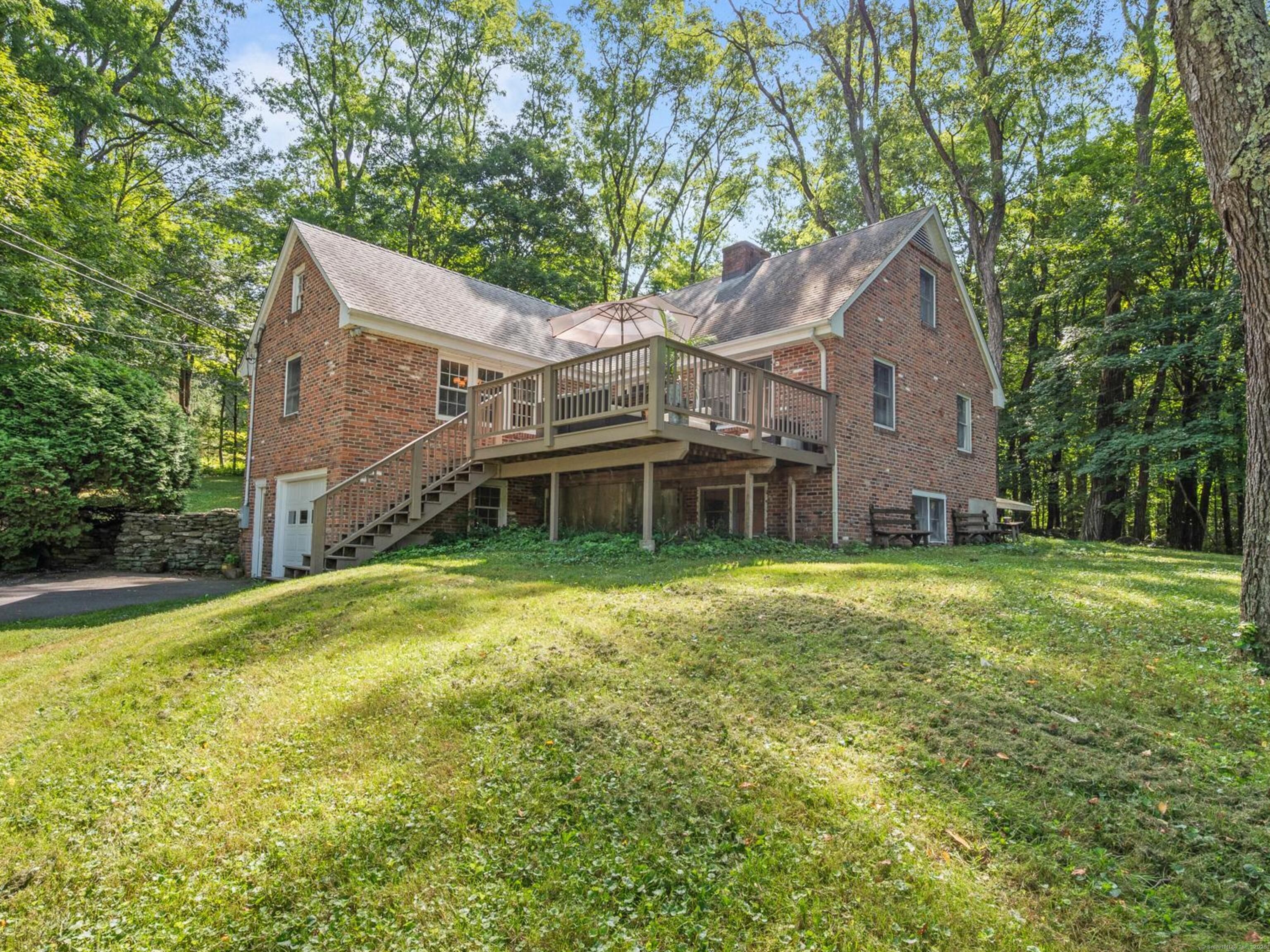 a front view of a house with a garden and yard