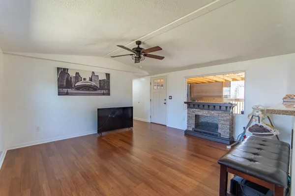 a living room with furniture wooden floor and a fireplace