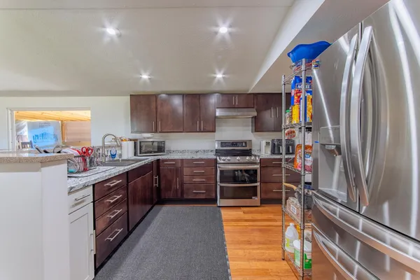 a kitchen with stainless steel appliances granite countertop a stove and a sink