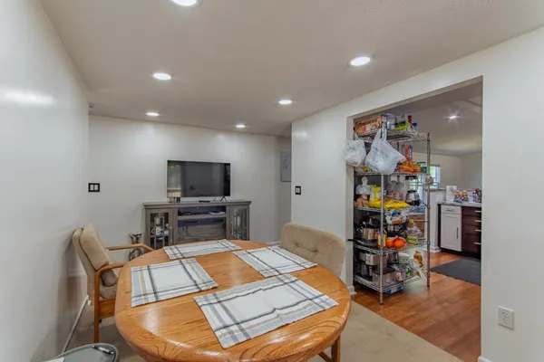 a view of a a dining room with furniture window and wooden floor