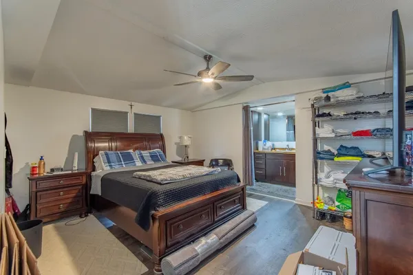 a bedroom with a bed and a chandelier