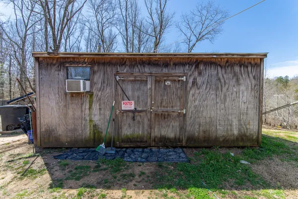 a view of a dry yard with wooden fence