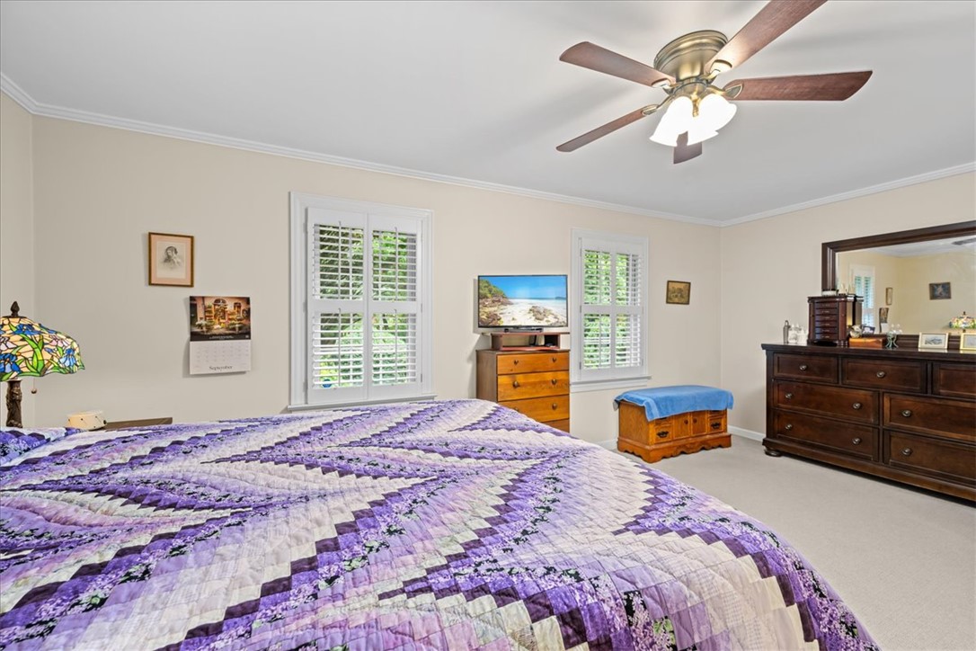2004 Cardinal Park Drive Anderson, SC 29621 - Photo 20 of 40 Plush carpeting anchors this spacious bedroom featuring clean crown molding and classic plantation shutters.